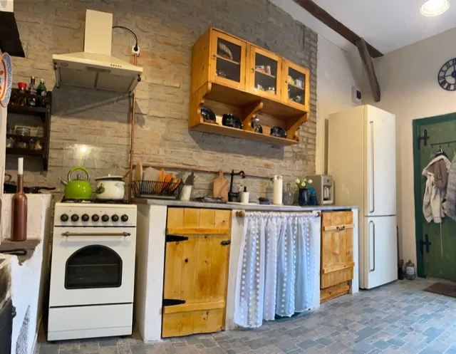 The Baking Room kitchen with traditional appliances and rustic shelving