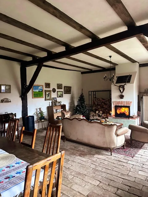 The barn gathering room with antique furniture and warm lighting